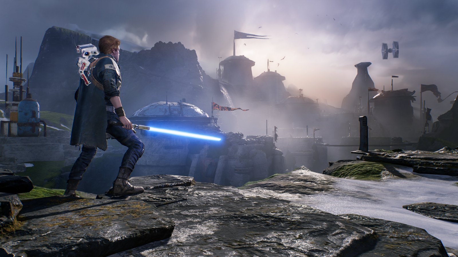 Cal Kestis stands at the edge of a cliff, overlooking a world's landscape, with BD-1 perched on his shoulder and a lightsaber in his hand.